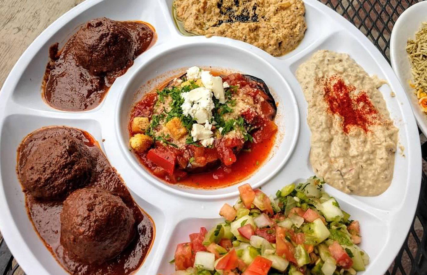 Persian and Mediterranean appetizer platter with hummus, eggplant dip and Shirazi salad